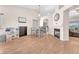 Spacious living room with a fireplace, dining area, and modern flooring at 452 Waterwheel Falls Dr, Henderson, NV 89015