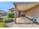 Welcoming covered porch area with a seating bench and tidy landscaping at 452 Waterwheel Falls Dr, Henderson, NV 89015