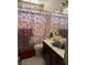 Bathroom with a shower tub combo, curtain, single sink vanity, and tile flooring at 5065 Celebrity Cir, Las Vegas, NV 89119