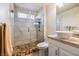 Modern bathroom with walk-in shower, glass door, and vanity with a sink at 5449 Desert Spring Rd, Las Vegas, NV 89149