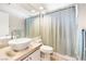 Bathroom with modern vessel sink on a marble countertop, a large mirror, and a shower with a patterned curtain at 5449 Desert Spring Rd, Las Vegas, NV 89149