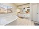 Bright bathroom with a soaking tub, dual sinks, and a large window at 5449 Desert Spring Rd, Las Vegas, NV 89149
