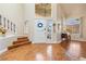 Elegant entryway with hardwood floors, staircase, and large bright window at 5449 Desert Spring Rd, Las Vegas, NV 89149