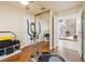 Home gym with an elliptical machine, mirrored closet, and an open view to the front entryway at 5449 Desert Spring Rd, Las Vegas, NV 89149