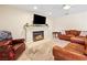 Cozy living room features a fireplace with white mantle and comfortable leather seating at 5449 Desert Spring Rd, Las Vegas, NV 89149