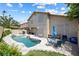 Spacious backyard with rock pool, patio area with table and chairs, perfect for outdoor entertaining at 5449 Desert Spring Rd, Las Vegas, NV 89149