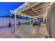 Backyard showcasing a covered patio, seating area, string lights, and low-maintenance landscaping at 58 Pleasant Dale Dr, Henderson, NV 89074