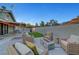 Spacious backyard with patio seating, artificial turf, and covered patio dining area at 58 Pleasant Dale Dr, Henderson, NV 89074