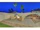 Private backyard featuring a patio, fire pit, firewood storage, and seating for outdoor relaxation at 58 Pleasant Dale Dr, Henderson, NV 89074