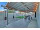 Wide view of backyard with covered patio, dining area, lounge area, and artificial grass at 58 Pleasant Dale Dr, Henderson, NV 89074