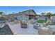 Fenced backyard with outdoor seating, fire pit, patio, and artificial grass at 58 Pleasant Dale Dr, Henderson, NV 89074