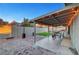 Backyard with covered patio, outdoor seating, fire pit, and artificial grass at 58 Pleasant Dale Dr, Henderson, NV 89074