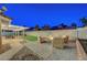 Inviting backyard featuring a patio area with comfortable seating around a fire pit and a covered outdoor dining space at 58 Pleasant Dale Dr, Henderson, NV 89074