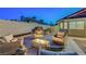 Relaxing backyard patio area featuring comfortable seating and a warm fire pit for evening enjoyment at 58 Pleasant Dale Dr, Henderson, NV 89074