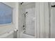 Marble tiled shower and tub with bright natural light and modern fixtures at 58 Pleasant Dale Dr, Henderson, NV 89074