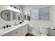 Bright bathroom with dual sinks, modern fixtures, and a walk-in shower at 58 Pleasant Dale Dr, Henderson, NV 89074