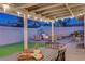 Inviting covered patio featuring outdoor seating, lighting, and a green synthetic grass area at 58 Pleasant Dale Dr, Henderson, NV 89074
