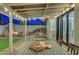 Charming covered patio features a dining area, seating, and outdoor ambiance with landscape views at 58 Pleasant Dale Dr, Henderson, NV 89074