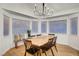 Cozy dining area with a modern chandelier, light wood table, and lots of natural light at 58 Pleasant Dale Dr, Henderson, NV 89074
