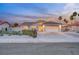 Charming single-story home featuring a two-car garage, desert landscaping, and welcoming curb appeal at twilight at 58 Pleasant Dale Dr, Henderson, NV 89074