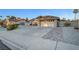 Charming single-story home boasting a two-car garage and a well-manicured front yard with desert landscaping and inviting curb appeal at 58 Pleasant Dale Dr, Henderson, NV 89074
