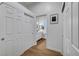 Hallway with view into a bright bathroom, closet, and hardwood flooring at 58 Pleasant Dale Dr, Henderson, NV 89074