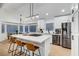 Bright kitchen with white cabinets, stainless steel appliances, and an island with bar stools at 58 Pleasant Dale Dr, Henderson, NV 89074