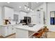 Modern kitchen featuring white cabinetry, stainless steel appliances, and an island with bar seating at 58 Pleasant Dale Dr, Henderson, NV 89074