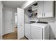Bright laundry room with newer appliances and storage shelves at 58 Pleasant Dale Dr, Henderson, NV 89074