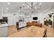 Open-concept living area boasts sleek flooring, high ceilings, a modern kitchen, and a cozy fireplace at 58 Pleasant Dale Dr, Henderson, NV 89074