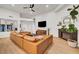 Spacious living room with a leather sectional sofa, fireplace, and lots of natural light at 58 Pleasant Dale Dr, Henderson, NV 89074