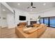 Bright living room featuring a modern fireplace, sleek ceiling fan, and access to the backyard at 58 Pleasant Dale Dr, Henderson, NV 89074