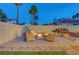 Inviting outdoor seating area with a fire pit, surrounded by manicured landscaping at 58 Pleasant Dale Dr, Henderson, NV 89074