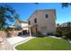 View of the backyard with artificial turf, a covered patio, and a block wall fence for privacy at 6002 Stone Hollow Ave, Las Vegas, NV 89156