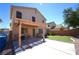 Relaxing covered patio area and artificial turf provide a nice backyard escape at 6002 Stone Hollow Ave, Las Vegas, NV 89156