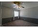 Simple bedroom with carpeted floors, paneled walls, and a single window for natural light at 6002 Stone Hollow Ave, Las Vegas, NV 89156