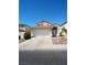 Two-story home with a two-car garage, neutral stucco exterior, and a tile roof at 6002 Stone Hollow Ave, Las Vegas, NV 89156