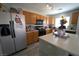 Functional kitchen with a central island, wooden cabinets, and modern appliances, providing a practical cooking space at 6002 Stone Hollow Ave, Las Vegas, NV 89156