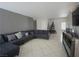 Spacious living room with cozy sectional sofa, neutral walls, and large windows for natural light at 6002 Stone Hollow Ave, Las Vegas, NV 89156