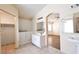 Bathroom features a walk-in tub, vanity with sink, and tiled floors, with view to living room at 6016 Bungalow Bay St, Las Vegas, NV 89130