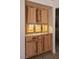 Charming built-in cabinetry with accent lighting, granite countertop, wooden cabinetry and custom tile floors at 6016 Bungalow Bay St, Las Vegas, NV 89130