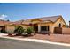 Charming single-story home featuring a tile roof, desert landscaping, and a three-car garage at 6016 Bungalow Bay St, Las Vegas, NV 89130