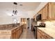 Well-equipped kitchen with stone countertops, stainless appliances, and wood cabinets at 6016 Bungalow Bay St, Las Vegas, NV 89130