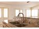 Close up of kitchen sink with stone countertops and abundant natural light at 6016 Bungalow Bay St, Las Vegas, NV 89130
