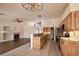 Spacious open-concept living room with tile flooring, a fireplace and modern kitchen at 6016 Bungalow Bay St, Las Vegas, NV 89130