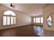 Spacious living room featuring laminate floors, arched window, and abundant light at 6016 Bungalow Bay St, Las Vegas, NV 89130