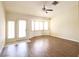 Spacious living room featuring wood flooring, ceiling fan, and a bay window at 6016 Bungalow Bay St, Las Vegas, NV 89130