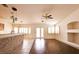 Bright living room with wood floors, ceiling fan, and large windows at 6016 Bungalow Bay St, Las Vegas, NV 89130