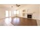 Open living room featuring a fireplace and sliding glass doors at 6016 Bungalow Bay St, Las Vegas, NV 89130