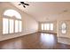 Bright living room featuring arched windows, and wood-look flooring at 6016 Bungalow Bay St, Las Vegas, NV 89130